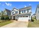 Charming home with a two-car garage, manicured lawn, and blue siding at 2008 Campana Dr, Raleigh, NC 27603