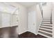 A spacious foyer featuring stairs, white trim, hardwood flooring, and an entry door at 2008 Campana Dr, Raleigh, NC 27603