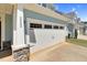 Attached two-car garage with traditional carriage doors and stone accents at 2008 Campana Dr, Raleigh, NC 27603