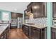 Modern kitchen features dark cabinetry, stainless steel appliances, and a stylish backsplash at 2008 Campana Dr, Raleigh, NC 27603