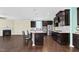Open concept kitchen features dark cabinets, stainless appliances, granite counters and adjacent living area with fireplace at 2008 Campana Dr, Raleigh, NC 27603