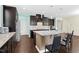 Spacious kitchen with a large island, stainless steel appliances, dark cabinetry, and a stylish backsplash at 2008 Campana Dr, Raleigh, NC 27603