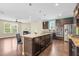 Bright kitchen with a center island, granite countertops, and an adjacent living area with a fireplace at 2008 Campana Dr, Raleigh, NC 27603