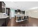 This kitchen features a large island with seating, granite countertops, and dark wood cabinets at 2008 Campana Dr, Raleigh, NC 27603