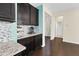 Kitchen featuring stainless steel appliances, dark cabinets, mosaic tile backsplash, and granite countertops at 2008 Campana Dr, Raleigh, NC 27603