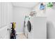 Laundry room featuring a white washer and dryer, shelving and a utility closet at 2008 Campana Dr, Raleigh, NC 27603