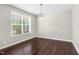 The living room features hardwood flooring, a window, and a hanging light fixture at 2008 Campana Dr, Raleigh, NC 27603