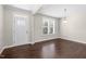 The living room features hardwood flooring, a window, and white trim at 2008 Campana Dr, Raleigh, NC 27603