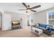 Cozy living room featuring a plush sofa, a modern TV stand with television, and a sleek white coffee table at 2008 Campana Dr, Raleigh, NC 27603