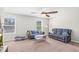 This comfortable living room features two sofas, a modern ceiling fan, and natural light from the bright windows at 2008 Campana Dr, Raleigh, NC 27603