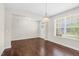 The living room features hardwood flooring, a window and an entry door at 2008 Campana Dr, Raleigh, NC 27603
