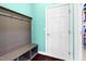 Mudroom featuring a bench with storage cubbies, coat hooks, and a door for easy access to other areas at 2008 Campana Dr, Raleigh, NC 27603