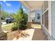 Cozy front porch with stone pillar accents and lush landscaping, offering a welcoming entrance at 2008 Campana Dr, Raleigh, NC 27603