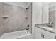 Stylish bathroom featuring tiled shower over tub and a granite topped vanity at 206 Jetson Creek Way, Youngsville, NC 27596
