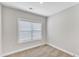Neutral bedroom features plush carpet, a window with blinds, and fresh, neutral paint at 206 Jetson Creek Way, Youngsville, NC 27596