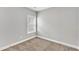 Simple, carpeted room featuring a window with blinds and neutral paint and trim at 206 Jetson Creek Way, Youngsville, NC 27596