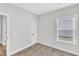Bright bedroom featuring neutral carpet and paint, a window and white trim at 206 Jetson Creek Way, Youngsville, NC 27596