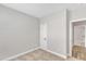 Cozy bedroom with neutral carpet, trim, and paint, with a doorway to another room at 206 Jetson Creek Way, Youngsville, NC 27596
