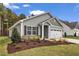 Charming single-Gathering home featuring stone accents, manicured landscaping, and a two-car garage at 206 Jetson Creek Way, Youngsville, NC 27596