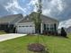 Well-maintained single-story home with a fresh lawn and newly planted tree in the front yard at 206 Jetson Creek Way, Youngsville, NC 27596