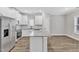 Bright kitchen featuring white cabinets, stainless steel appliances, and granite countertops at 206 Jetson Creek Way, Youngsville, NC 27596