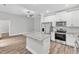 Stylish kitchen with white cabinetry, granite countertops, and stainless steel appliances at 206 Jetson Creek Way, Youngsville, NC 27596