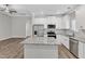 Modern kitchen boasting stainless steel appliances, granite counters, and large center island at 206 Jetson Creek Way, Youngsville, NC 27596