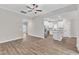 Open-concept living room and kitchen with stainless steel appliances and hardwood floors at 206 Jetson Creek Way, Youngsville, NC 27596