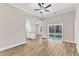 Open-concept living room with wood-look floors, island and backyard access at 206 Jetson Creek Way, Youngsville, NC 27596
