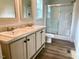 A bathroom featuring a double sink vanity and shower with glass doors at 209 King St, Oxford, NC 27565