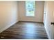 This bedroom features new wood flooring and a window with natural light at 209 King St, Oxford, NC 27565