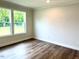 A bright bedroom with new floors and large windows at 209 King St, Oxford, NC 27565