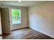 Neutral bedroom with wood floors and window letting in natural light at 209 King St, Oxford, NC 27565