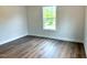 This bedroom features new wood flooring and a window with natural light at 209 King St, Oxford, NC 27565