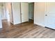 This bedroom includes new wood floors and multiple doors at 209 King St, Oxford, NC 27565