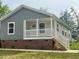 Home with gray siding, white trim, replacement windows, and a quaint white front porch at 209 King St, Oxford, NC 27565
