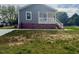 Home featuring gray siding, replacement windows, and a white-column front porch at 209 King St, Oxford, NC 27565