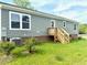 Rear view of the home featuring vinyl siding, replacement windows, and a new deck at 209 King St, Oxford, NC 27565