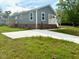 Angle view of the home featuring vinyl siding, replacement windows, and a new driveway at 209 King St, Oxford, NC 27565