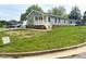 View of home exterior with sign in yard at 209 King St, Oxford, NC 27565