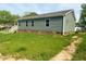View of back and side of single story home with gray siding at 209 King St, Oxford, NC 27565