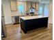 Modern kitchen with island, stainless steel appliances, and natural light at 209 King St, Oxford, NC 27565