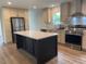 Spacious kitchen island with white countertop and dark cabinetry at 209 King St, Oxford, NC 27565