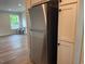 A kitchen featuring stainless steel refrigerator and white cabinets at 209 King St, Oxford, NC 27565