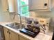 A kitchen sink area with appliances and new cabinets at 209 King St, Oxford, NC 27565