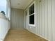 Covered porch with wood floor and white railings at 209 King St, Oxford, NC 27565