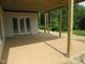 Outdoor patio perfect for entertaining, featuring wood beams and a spacious concrete deck at 2590 Silas Peak Ln, Apex, NC 27523
