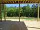 Unfinished basement with a concrete floor and bare framing overlooks beautiful trees at 2590 Silas Peak Ln, Apex, NC 27523