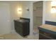 Bathroom with cabinet sink featuring a grey counter, contemporary lights, and an open closet at 2590 Silas Peak Ln, Apex, NC 27523