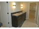 Bathroom vanity features a gray counter, stylish lighting, and plenty of storage at 2590 Silas Peak Ln, Apex, NC 27523